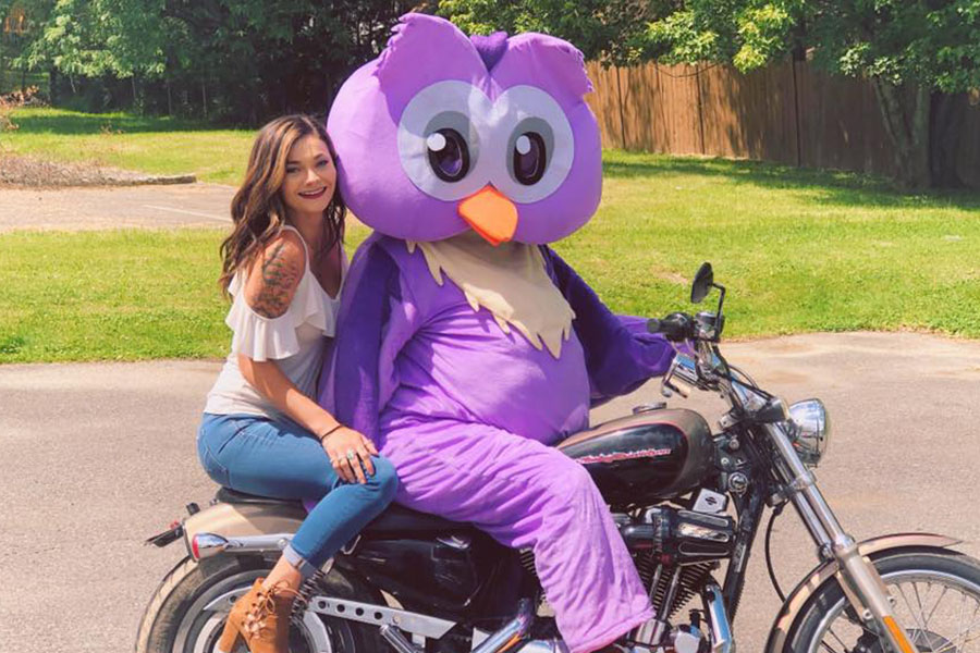 Contact - Arica and the Company Mascot, Athena Riding a Motorcycle on A Sunny Day